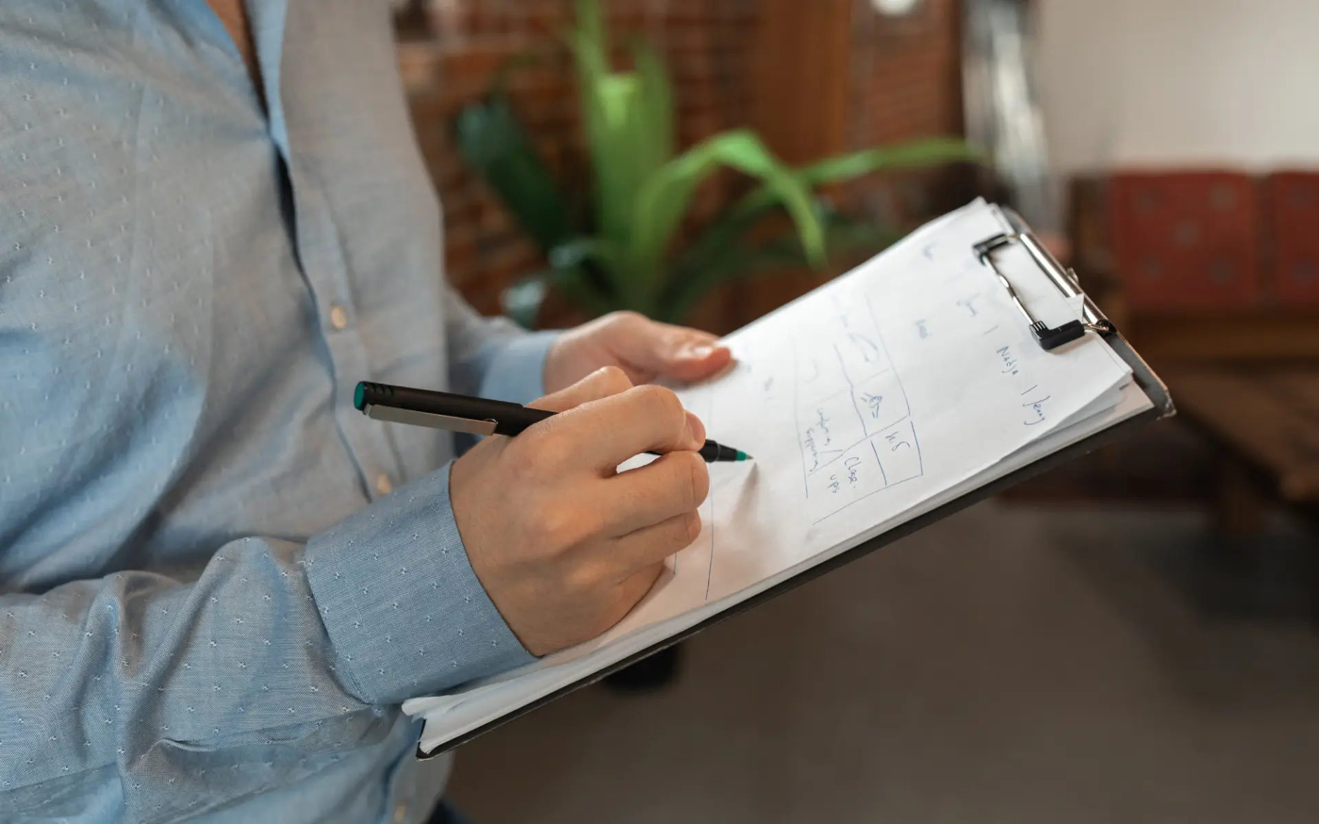 Researcher taking notes on a clipboard during the ARCHIPELAGO needs assessment